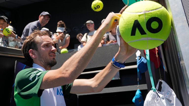 Daniil Medvedev of Russia signs autographs after his first round match against Terence Atmane of France at the Australian Open tennis championships at Melbourne Park, Melbourne, Australia, Monday, Jan. 15, 2024. (AP Photo/Andy Wong)